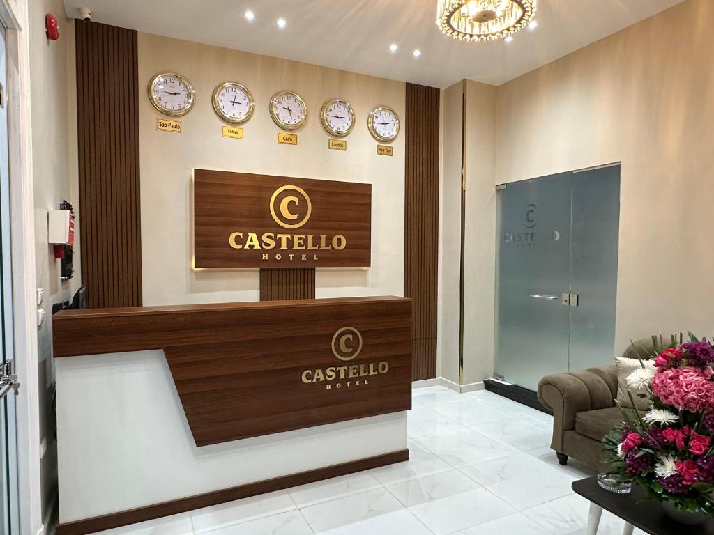 a lobby with clocks on the wall and a reception desk at CASTELLO HOTEL in Cairo