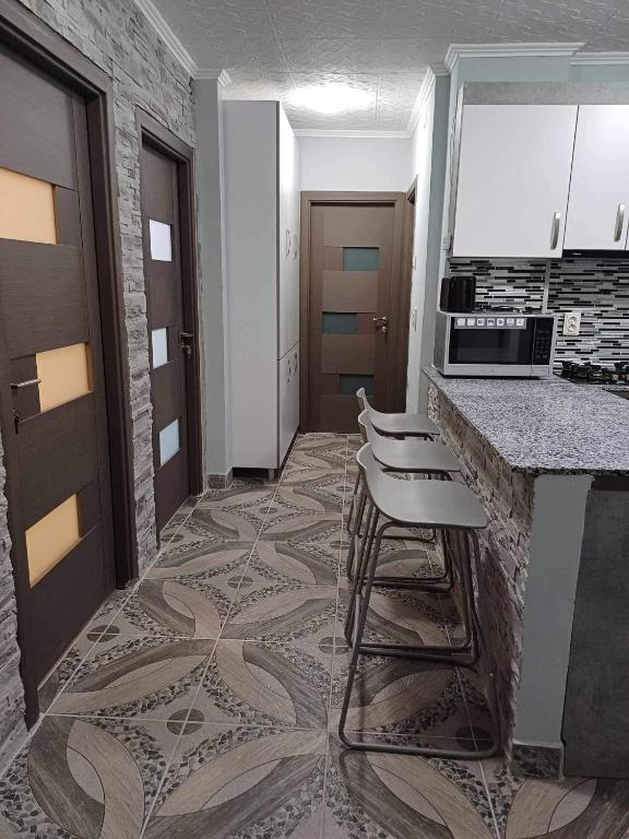 a kitchen with a counter and stools in a room at Pleasure Palace in Sovata
