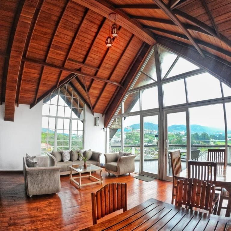 a living room with a couch and a table at Dewdrops at Lake Gregory in Nuwara Eliya