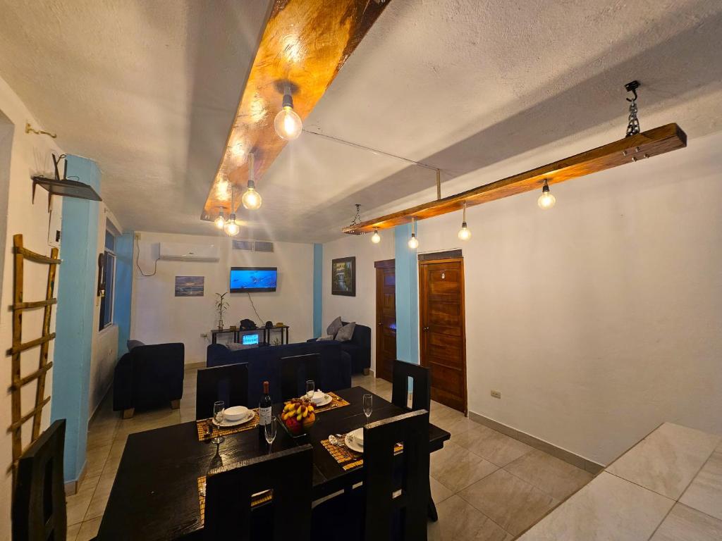 a living room with a table and a dining room at Lovely Inn in San Cristobal