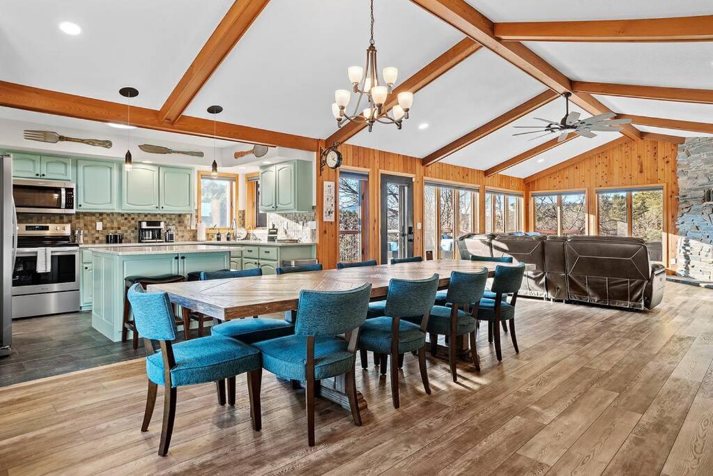 a kitchen and dining room with a table and chairs at Lodge at Mount Rushmore in Keystone