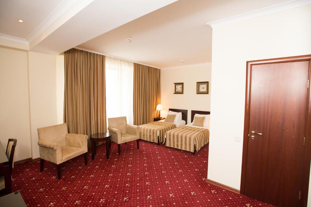 Postel nebo postele na pokoji v ubytování Jumbo Hotel