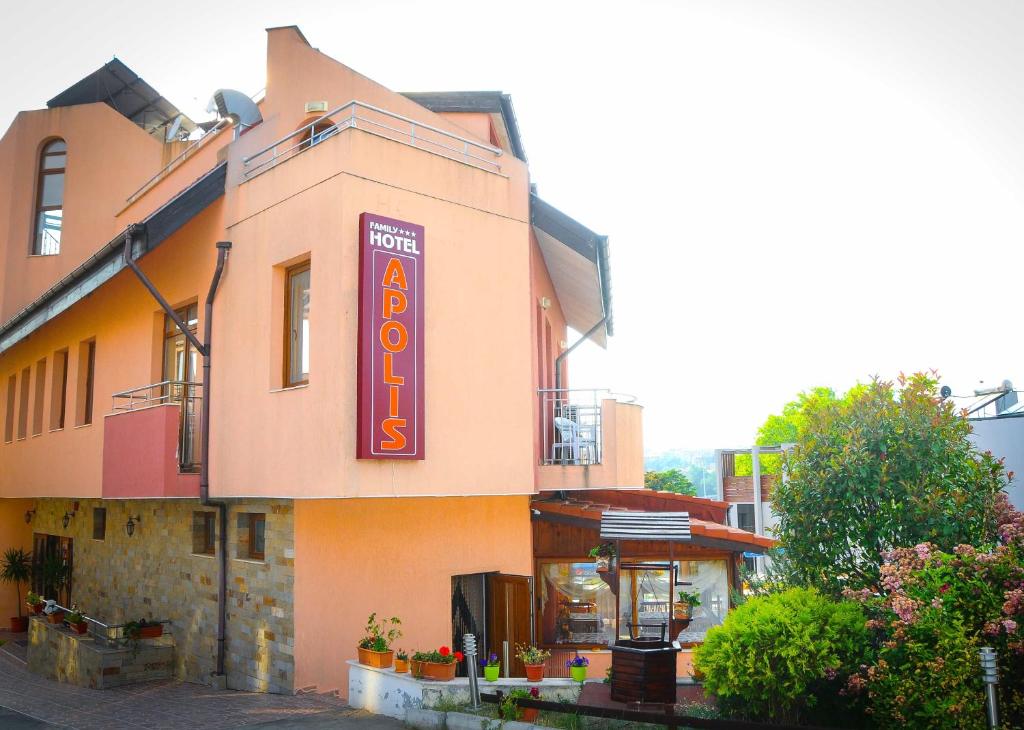 a building with a sign on the side of it at Hotel Apolis in Sozopol
