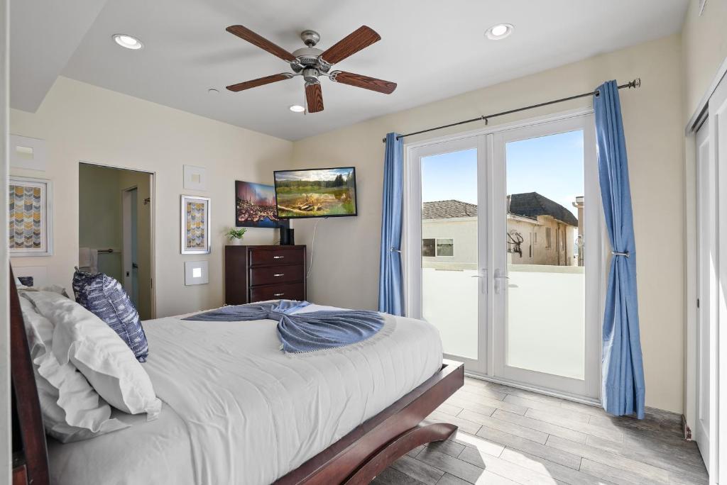 a bedroom with a bed and a ceiling fan at Ocean View Paradise w Private Patio & Spa in San Diego