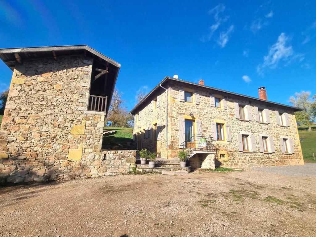 an old stone building with a roof on a field at Gîte Belmont-de-la-Loire, 6 pièces, 12 personnes - FR-1-496-304 in Belmont-de-la-Loire