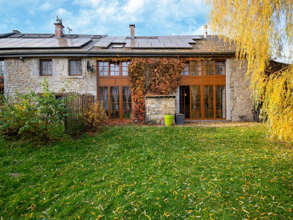 an old stone house with a green yard at Charming holiday home in Durbuy with garden in Durbuy