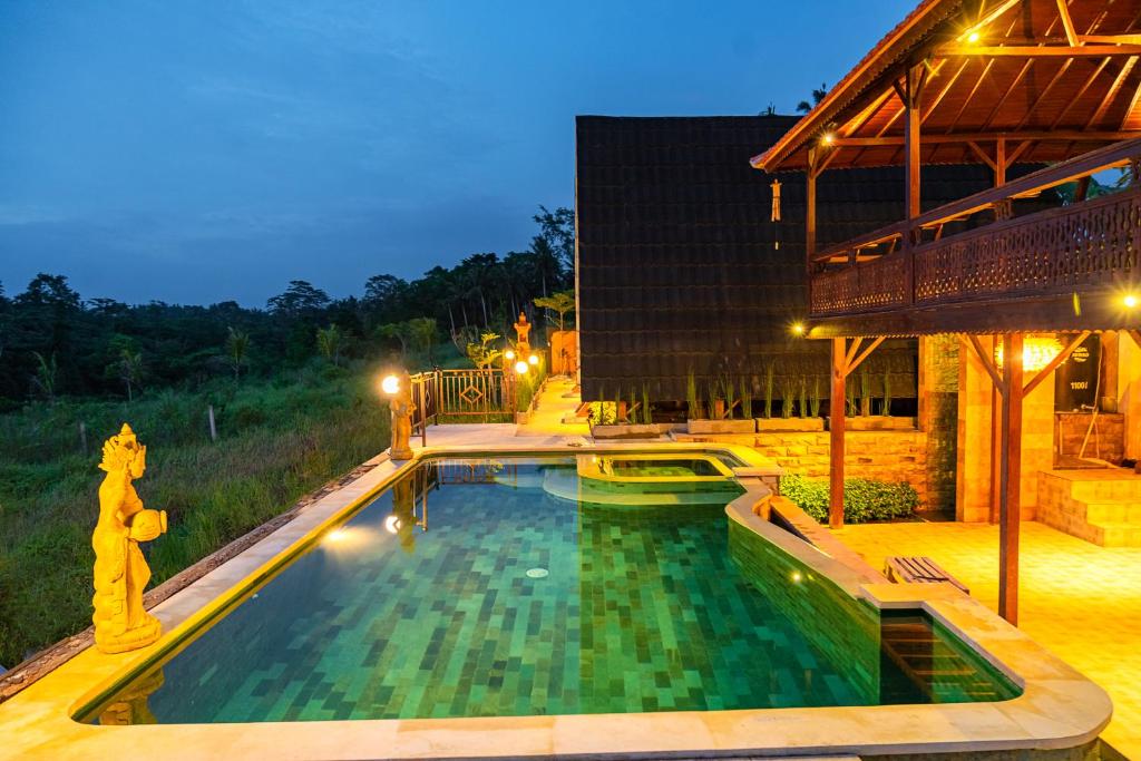 a swimming pool in the middle of a building at The Pyramid Ubud River Villas in Gianyar