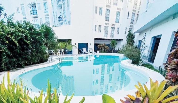 a large swimming pool in front of a building at La bella tagaytay- Casa Raffa in Tagaytay