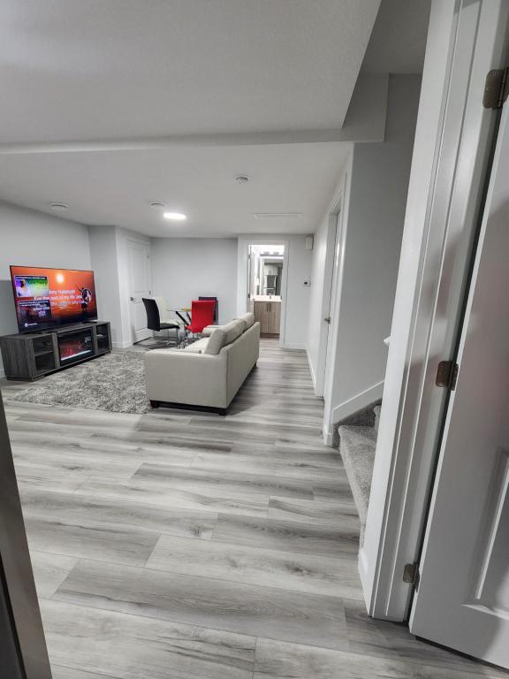 a living room with a couch and a television at Home Away From Home in Edmonton