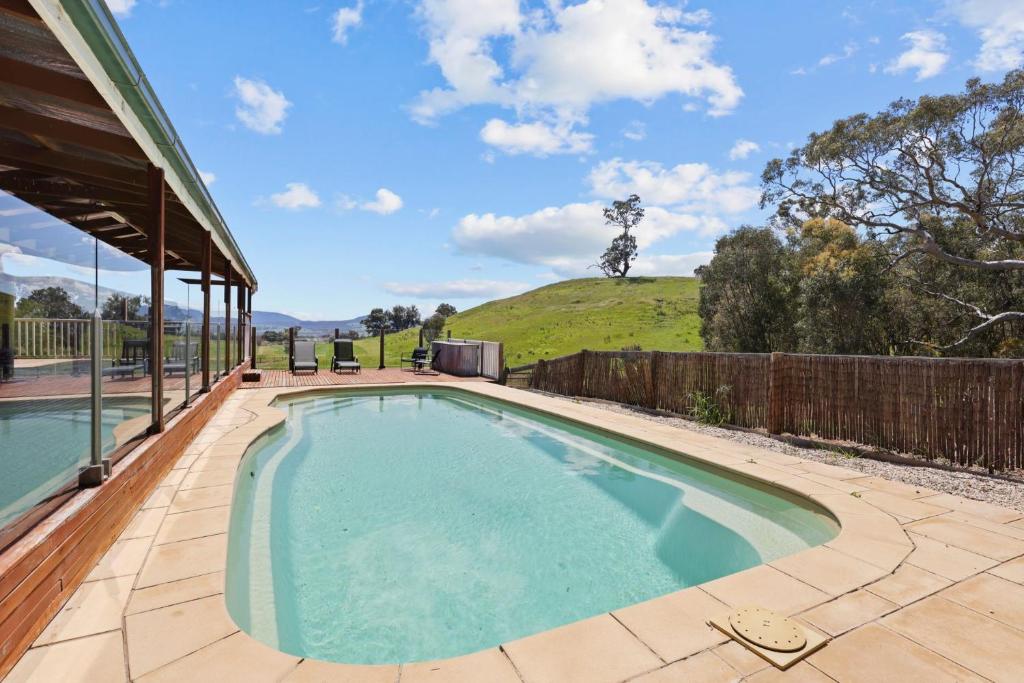 a swimming pool on a patio next to a house at Mansfield Hideaway - Sleeps 10 in Mansfield