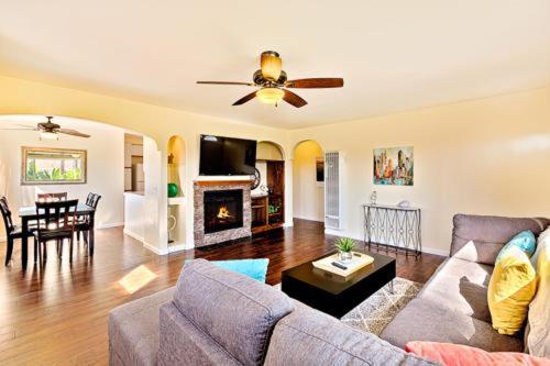 a living room with a couch and a ceiling fan at Pacific Oasis - Large Patio, Parking & Walk to Beach in San Diego