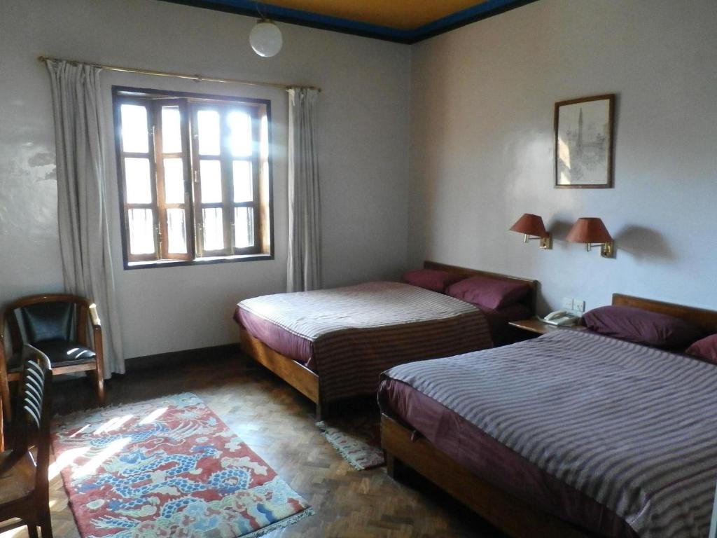 Postel nebo postele na pokoji v ubytování Vajra Hotel