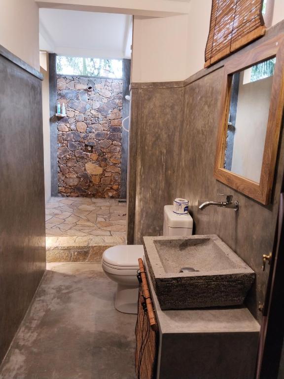 a bathroom with a toilet and a sink at Silva Rest in Unawatuna