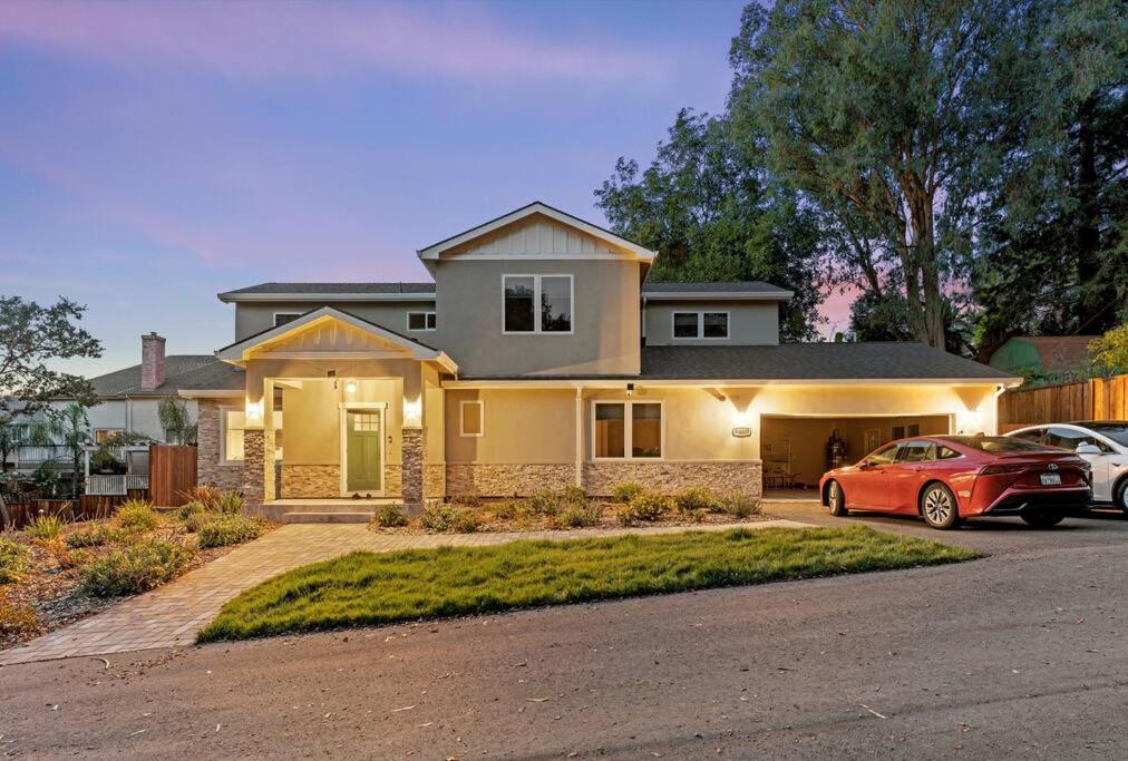 a house with two cars parked in a driveway at The Garden House--5 bedrooms, sleeps 12 in San Jose