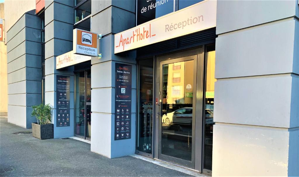 a building with a sign on the side of it at ApartHotel Sainte-Marthe in Avignon