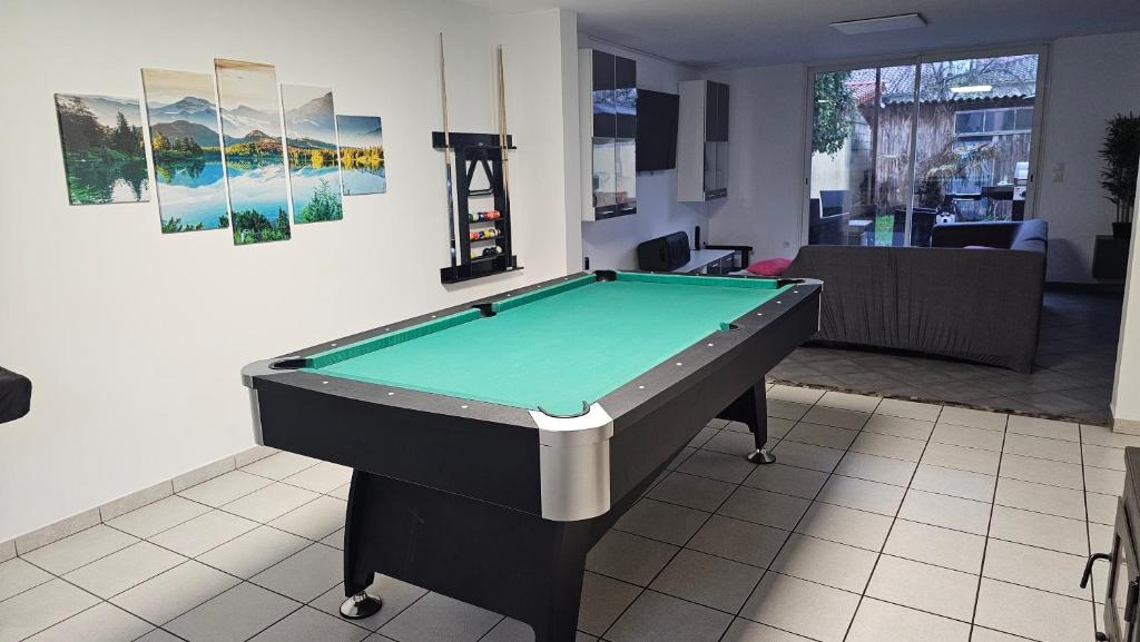 a pool table in a living room with ahibition at Bed To Rent - Maison Calme avec Jacuzzi sous Supplément in Bordeaux
