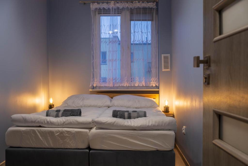 a large bed in a room with a window at CityOasis Apartment in Nowe Miasto Lubawskie