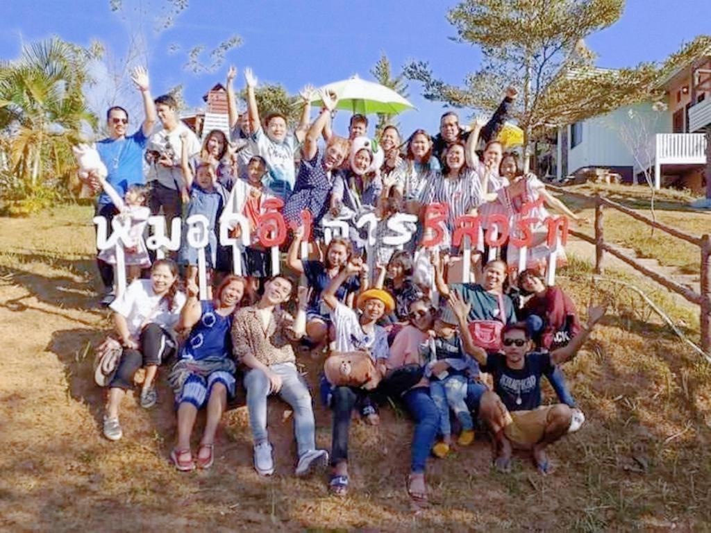 um grupo de pessoas estão posando para uma foto em หมอกอิงธาร รีสอร์ท เขาค้อ em Ban Khao Ya Nua