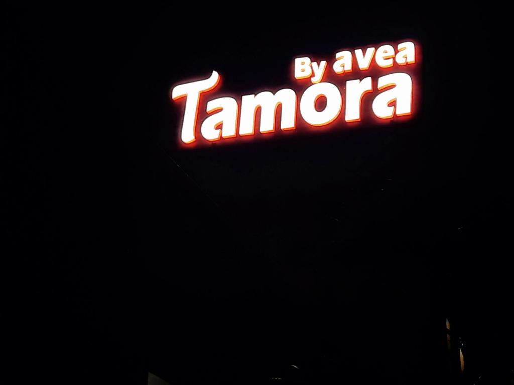 a neon sign for a tarmaarmaarma restaurant at night at Tamora By avea in Madurai