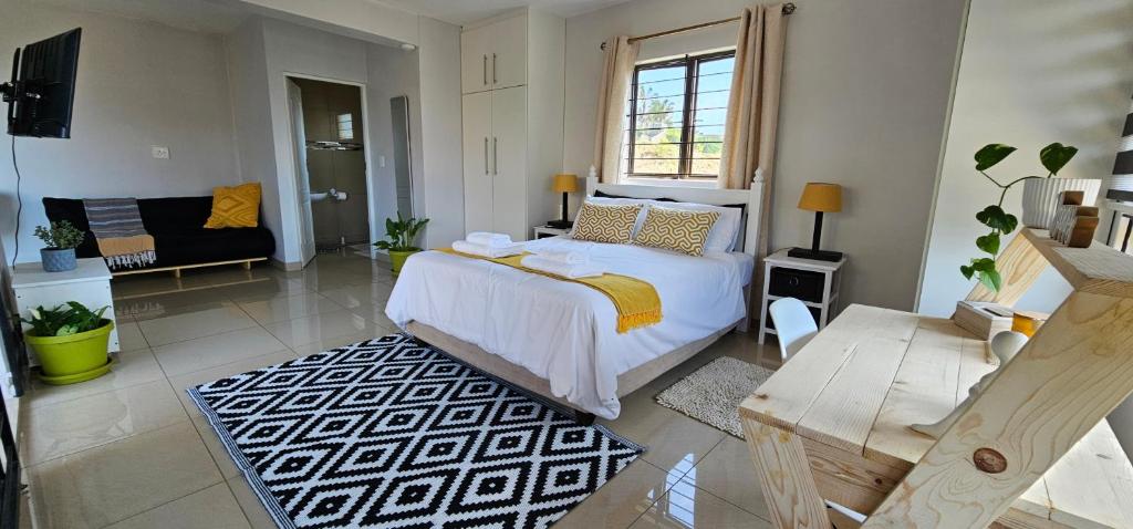 a bedroom with a bed and a living room at Your Happy Holiday Place in La Mercy