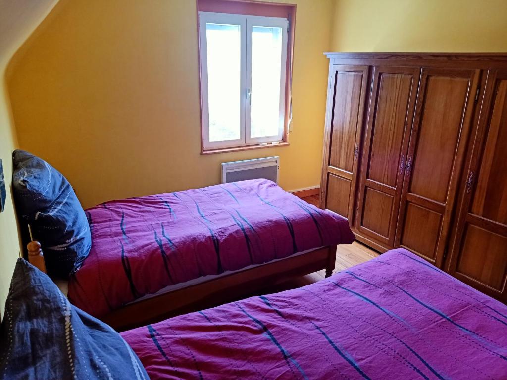 a bedroom with two beds and a window at Room Algo in Algolsheim