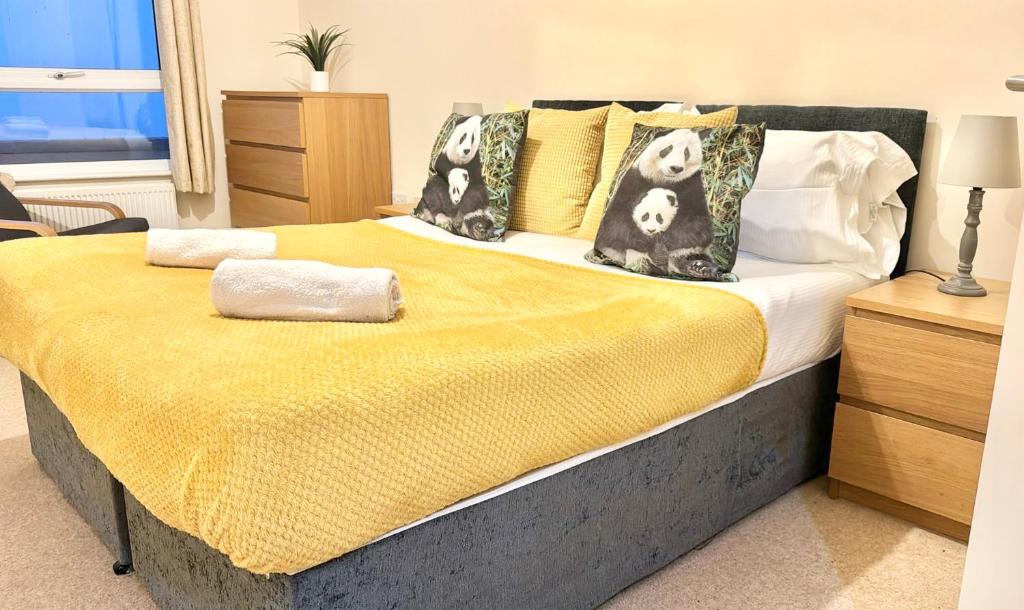 a bedroom with a large bed with a yellow blanket at Large 2 Bedroom Apartment in Ashford with PARKING in Ashford