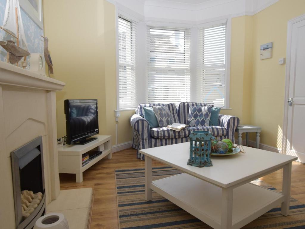 a living room with a couch and a fireplace at 3 bed in Eastbourne EHC04 in Eastbourne