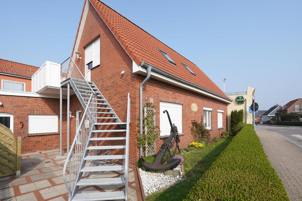 a metal staircase leading to a brick house at J. Apfeld Ferienwohnungen in Borkum