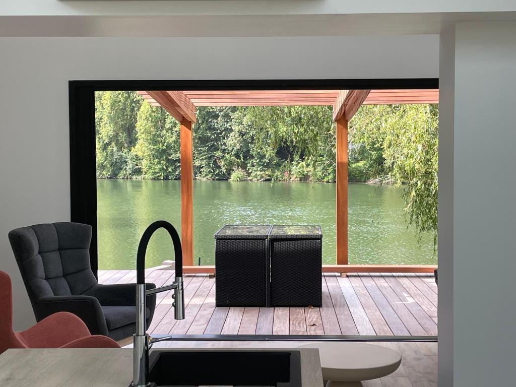 a living room with a view of a body of water at Au bal des hirondelles in Andé