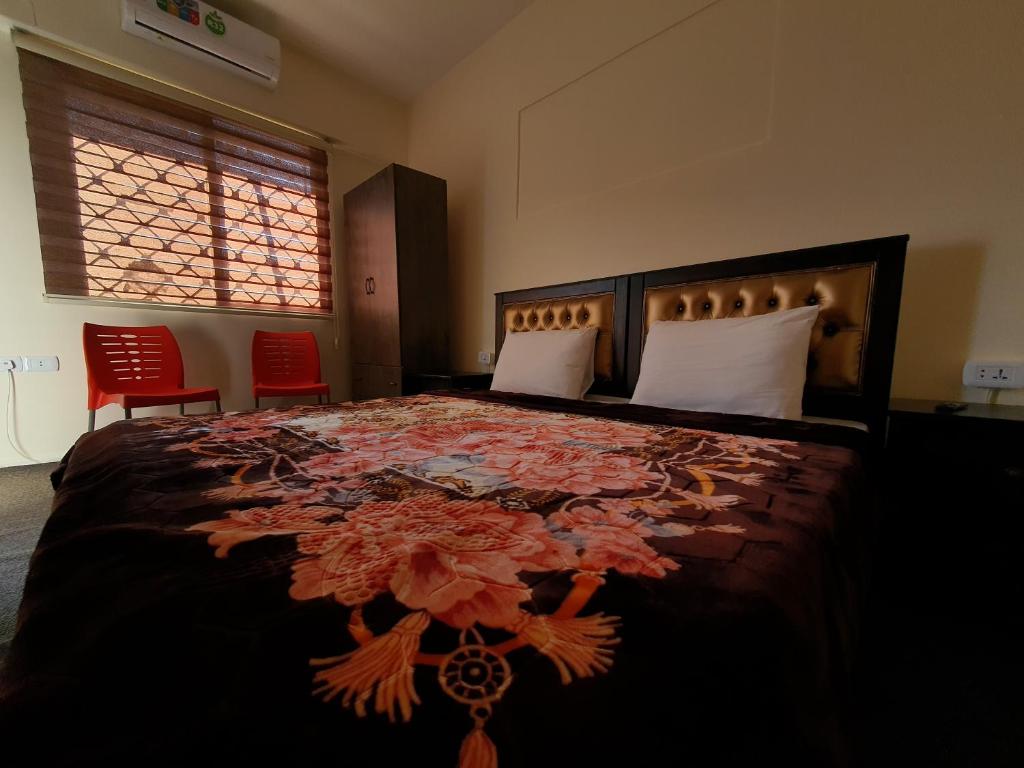 a bedroom with a large bed with a floral bedspread at Petraone in Wadi Musa