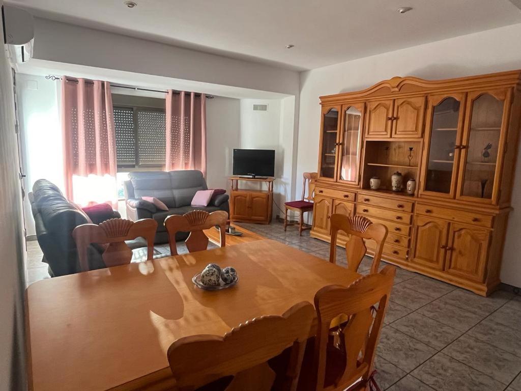 a living room with a wooden table and a couch at Apartamento La Ermita in Chulilla