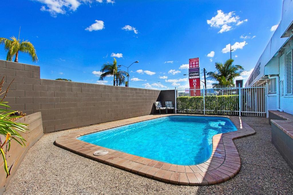 a swimming pool in the middle of a yard at Nambour Lodge Motel in Nambour