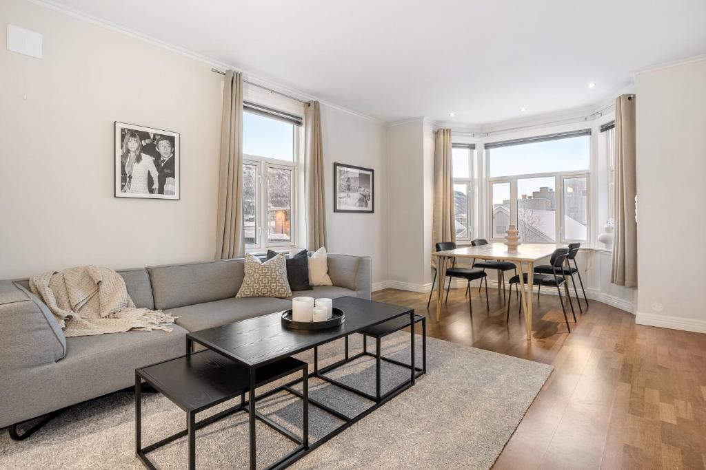 a living room with a couch and a table at Historical villa in the city center in Tromsø