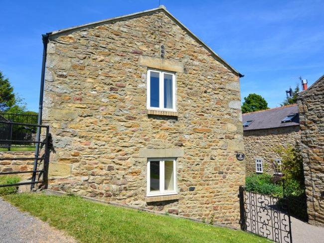 a stone building with two windows on the side of it at 3 Bed in Wolsingham 36671 in Wolsingham