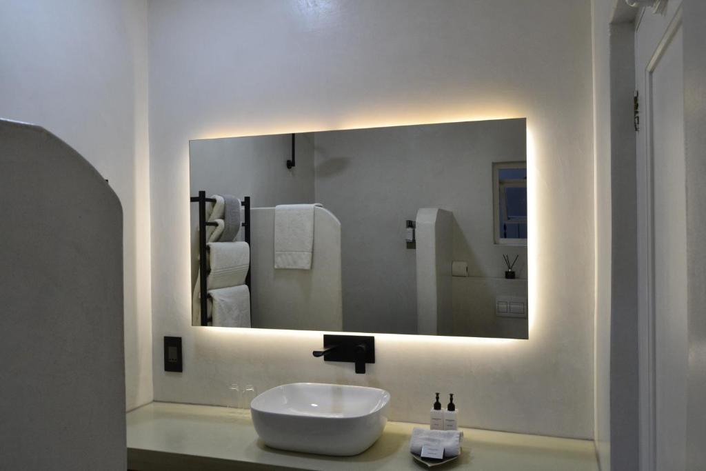 a bathroom with a sink and a large mirror at Auberge Burgundy Boutique Hotel & Spa in Hermanus