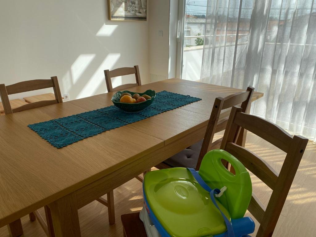 a dining room table with a bowl of fruit on it at Moradia com jaccuzzi e sky view in Bombarral