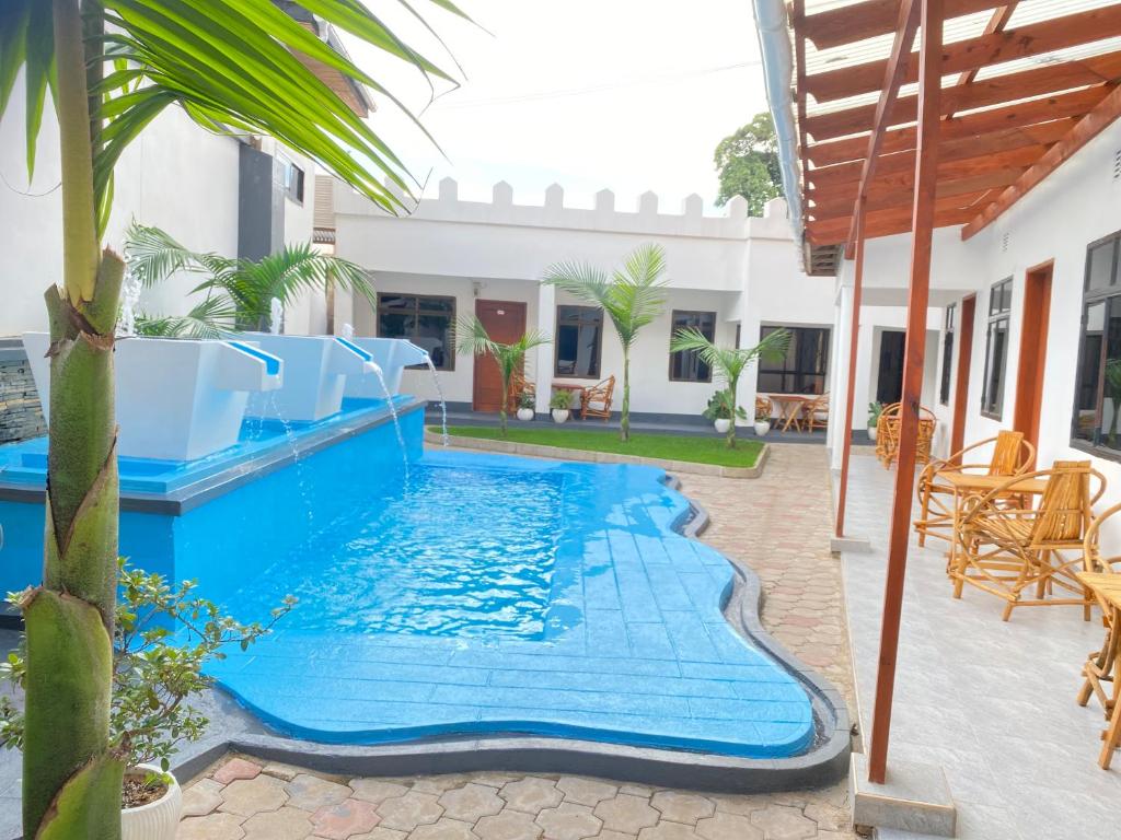 a swimming pool in a house with a blue swimming pool at Didas Villa in Arusha