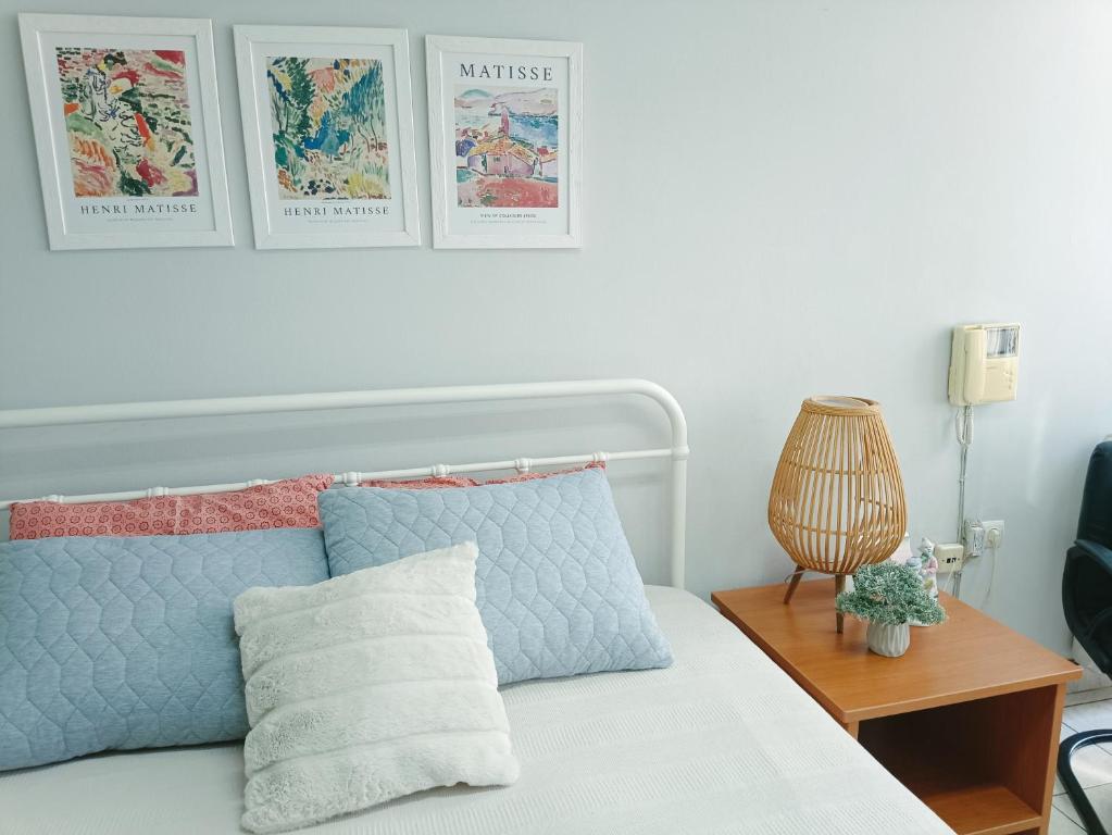 a bedroom with a bed with two pictures on the wall at Mary cozy house in Athens