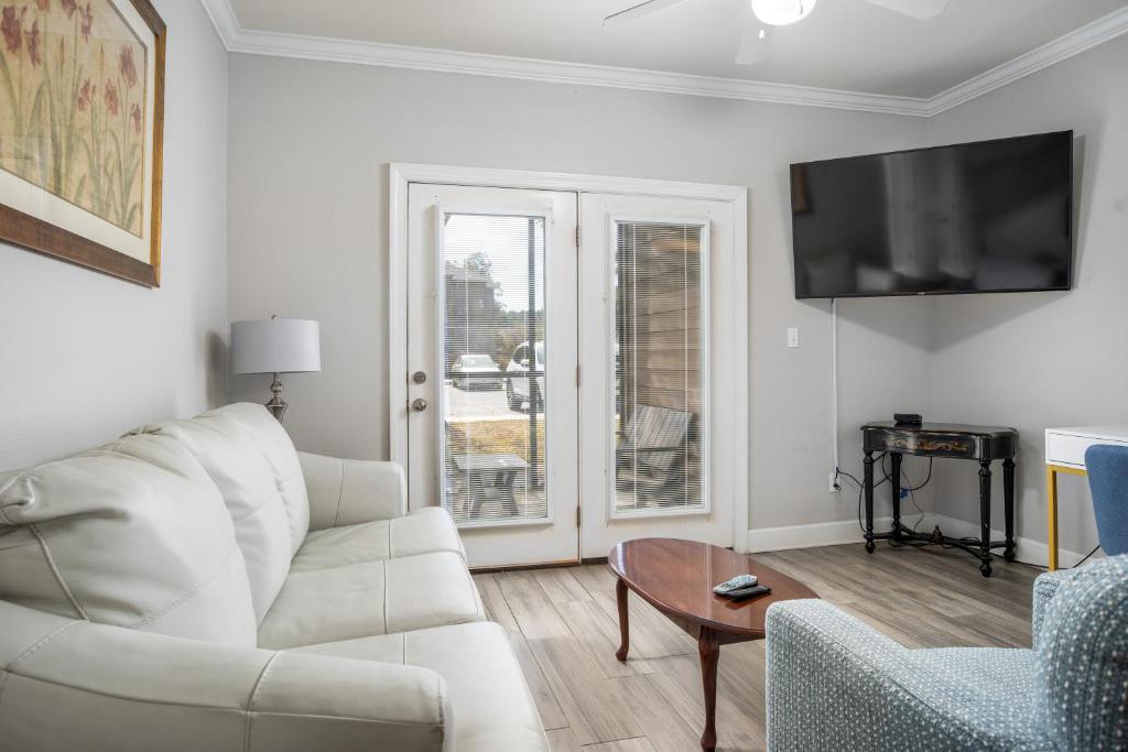 a living room with a white couch and a table at Park Avenue 109 in Foley