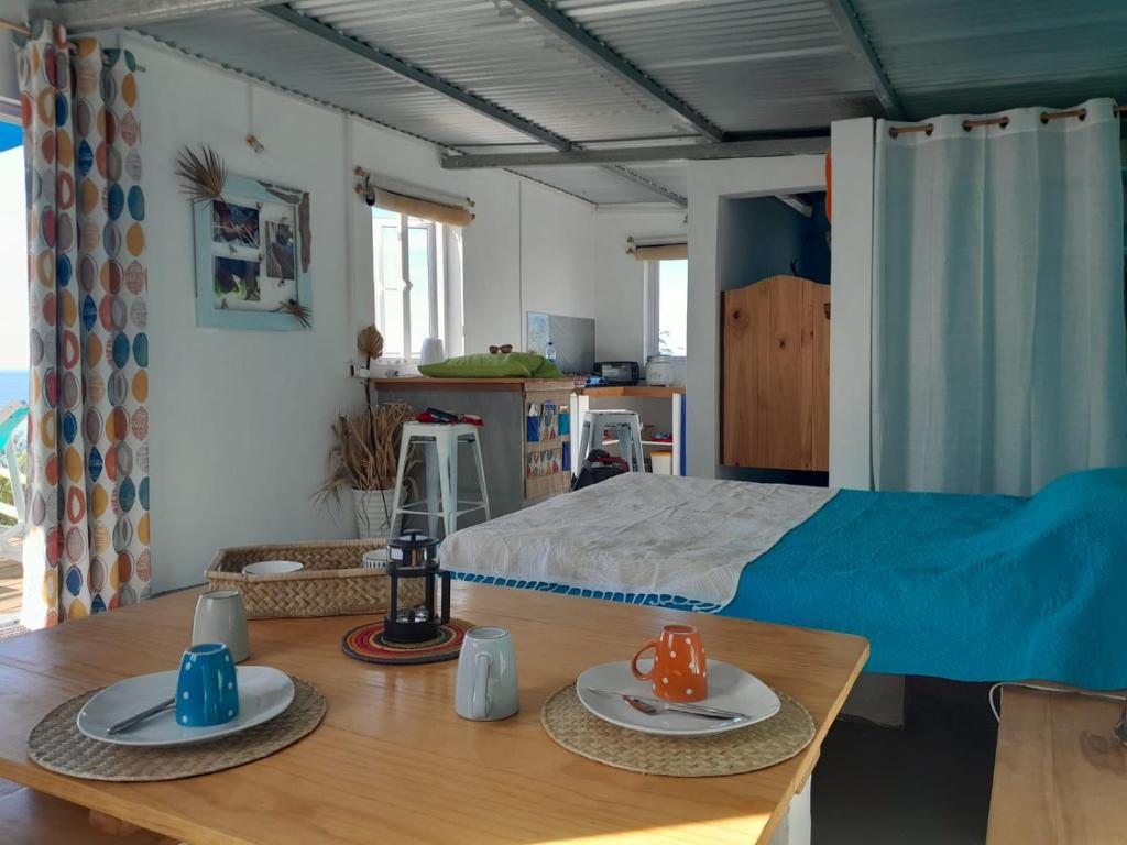 a bedroom with a bed and a table with plates on it at Blue View Terrace in Rodrigues Island