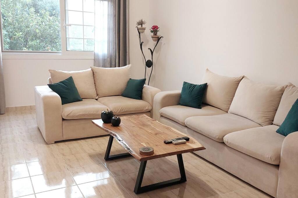 a living room with two couches and a coffee table at Apartment in Karellas near the airport in Paianía