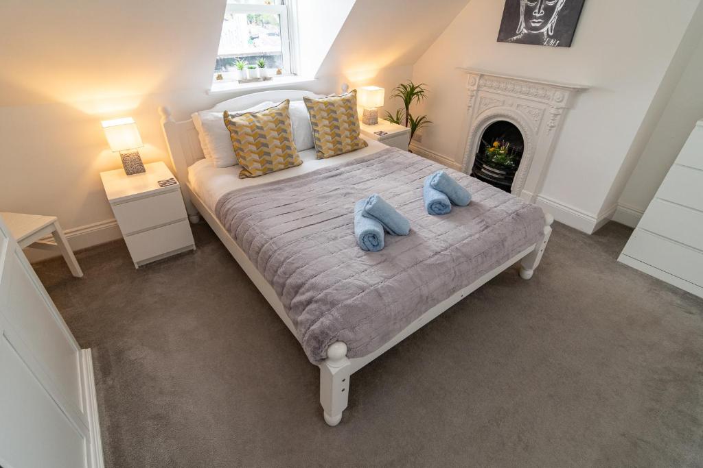 - une chambre avec un lit et 2 serviettes bleues dans l'établissement Light airy 3 bed Town Cntr flat 700m to the Beach, à Bournemouth