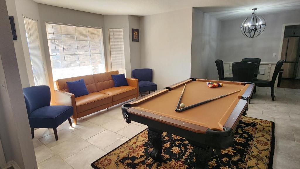 a living room with a pool table and a couch at Family Home in Oklahoma City