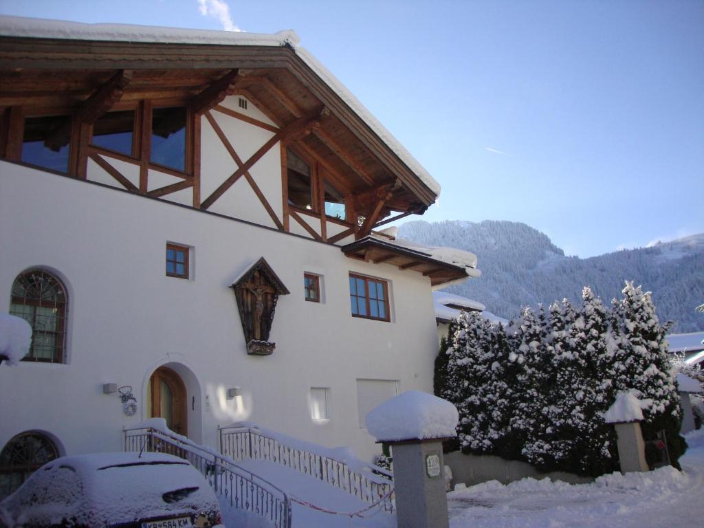 uma casa branca com neve ao lado em Haus Andreas em Kitzbühel