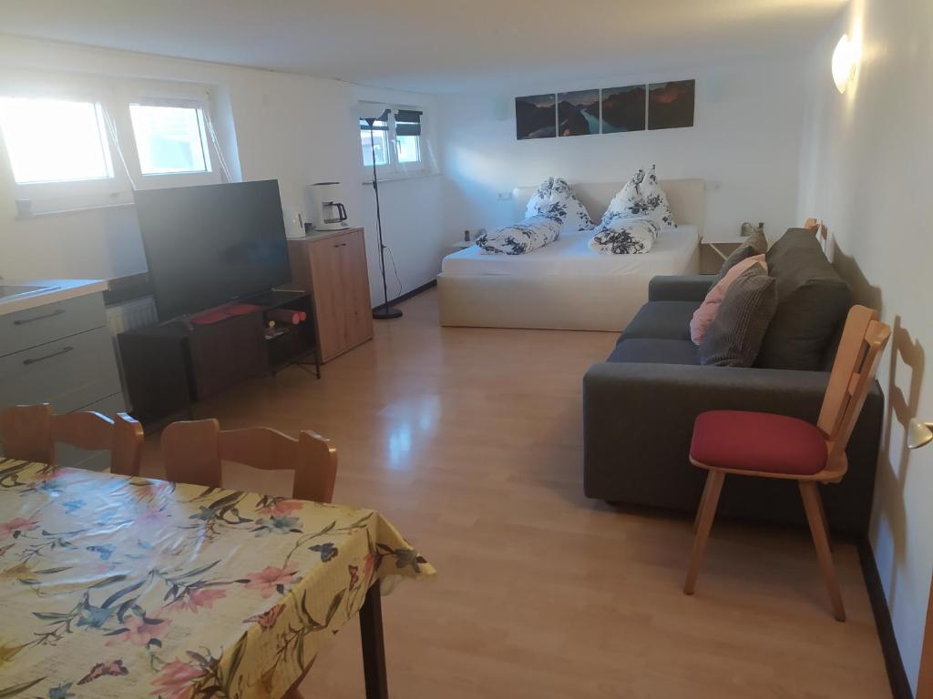 a living room with a couch and a bed at Ferienwohnung in Espenau