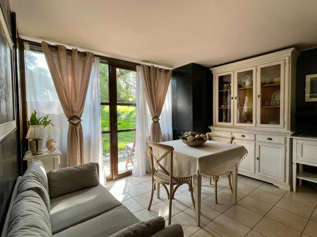uma sala de estar com uma mesa e um sofá em Villa Caffetto Dépendance nei pressi del Lago di Garda em Calcinato