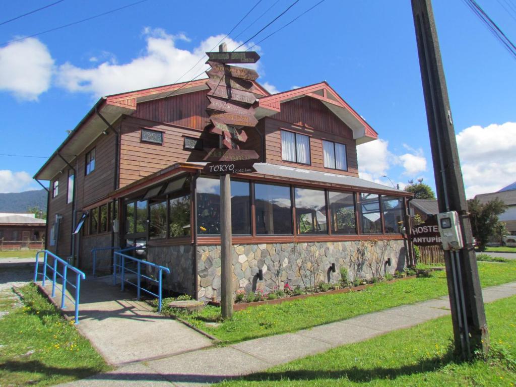 a large building with a house on top of it at Hostería Antupirén in Hornopiren