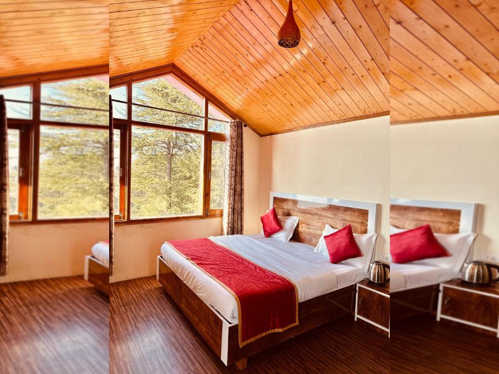 a bedroom with a large bed with red pillows at Divine Hills Mashobra in Shimla