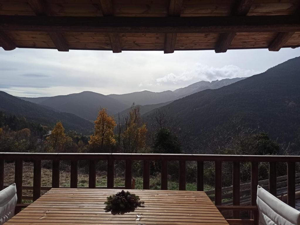 a table on a balcony with a view of mountains at Helmos Mountain Retreat in Zarouchla