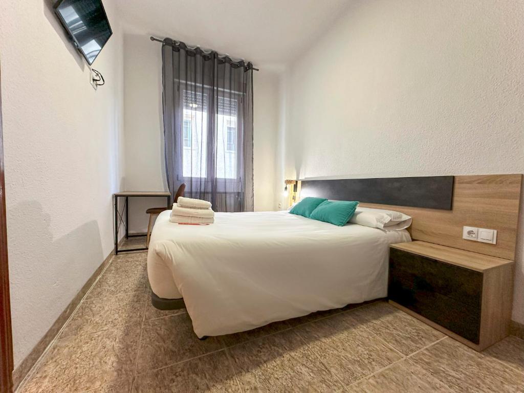 Ένα ή περισσότερα κρεβάτια σε δωμάτιο στο Pensión Recogidas